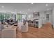 Open kitchen featuring modern cabinetry, large island, and eat-in dining area with abundant seating at 3625 Tuxedo Nw Rd, Atlanta, GA 30305