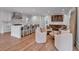 Open concept kitchen with white cabinetry, bar seating, and a cozy adjacent living area at 3625 Tuxedo Nw Rd, Atlanta, GA 30305