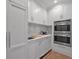 Convenient kitchenette area with stainless steel appliances, white cabinets, and marble countertop at 3625 Tuxedo Nw Rd, Atlanta, GA 30305