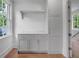 Bright laundry room features storage cabinets, hanging rack, and window for natural light at 3625 Tuxedo Nw Rd, Atlanta, GA 30305