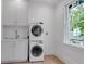 Laundry room with stackable washer/dryer, sink, and window for natural light at 3625 Tuxedo Nw Rd, Atlanta, GA 30305