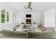 Bright living room with a stone fireplace, arched windows, and comfortable seating arrangement at 3625 Tuxedo Nw Rd, Atlanta, GA 30305