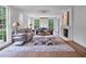 Well-lit living room featuring two sofas, a fireplace, and large windows for a bright and inviting atmosphere at 3625 Tuxedo Nw Rd, Atlanta, GA 30305