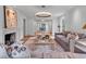 Open concept living room with fireplace, stylish decor, and bright, sunny views at 3625 Tuxedo Nw Rd, Atlanta, GA 30305