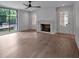 Bright living room with hardwood floors, fireplace, and access to the outdoors at 3625 Tuxedo Nw Rd, Atlanta, GA 30305