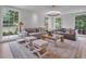 Spacious living room featuring hardwood floors, neutral tones, large windows, and elegant furnishings at 3625 Tuxedo Nw Rd, Atlanta, GA 30305