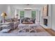 Elegant living room with fireplace, stylish decor, and large windows offering ample natural light at 3625 Tuxedo Nw Rd, Atlanta, GA 30305