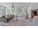 Open living room showcasing a fireplace, ample seating, and abundant natural light at 3625 Tuxedo Nw Rd, Atlanta, GA 30305