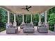 Covered patio with ceiling fan and comfortable seating with a treed view at 3625 Tuxedo Nw Rd, Atlanta, GA 30305
