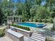 Backyard oasis featuring a pool, spa, cabana, and outdoor kitchen at 3625 Tuxedo Nw Rd, Atlanta, GA 30305