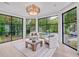 Bright sitting room with large windows offering views of the pool and landscaped yard at 3625 Tuxedo Nw Rd, Atlanta, GA 30305