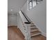 Elegant staircase with wood treads, white risers, and a black handrail at 3625 Tuxedo Nw Rd, Atlanta, GA 30305