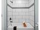 Bathroom featuring a white shower and bathtub with elegant black and white accents at 11 Pine St, Covington, GA 30014