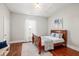Bedroom with hardwood floors, a large bed and white walls at 11 Pine St, Covington, GA 30014