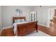 Bedroom with hardwood floors, a large bed, white walls, and a white cabinet at 11 Pine St, Covington, GA 30014
