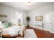 Bright bedroom featuring a bed between two windows with white walls, hardwood floors, and decor at 11 Pine St, Covington, GA 30014