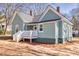 Exterior view of home with a light-green siding, a dark roof, and a front porch at 11 Pine St, Covington, GA 30014