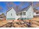 Beautifully renovated light blue home featuring a bright, inviting porch and well-maintained landscaping at 11 Pine St, Covington, GA 30014