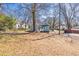 Charming light blue home with a welcoming front porch and a spacious, tree-filled front yard at 11 Pine St, Covington, GA 30014