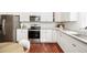 Updated kitchen with stainless steel appliances, granite countertops, white subway tile backsplash, and white cabinets at 11 Pine St, Covington, GA 30014