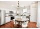 Bright eat-in kitchen featuring white cabinets, granite countertops, stainless steel appliances, and a dining table for casual meals at 11 Pine St, Covington, GA 30014