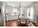 Bright eat-in kitchen with white cabinets, granite countertops, stainless steel appliances, and a dining table for casual meals at 11 Pine St, Covington, GA 30014