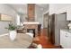 Open-concept living room featuring a striking brick fireplace and hardwood floors at 11 Pine St, Covington, GA 30014