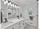 This bathroom has a double sink with quartz countertops, black hardware, and a sliding glass shower at 11415 Hutcheson Ferry Rd, Chattahoochee Hills, GA 30268