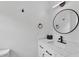 Modern bathroom with white vanity, quartz countertop, black accents, and round mirror at 11415 Hutcheson Ferry Rd, Chattahoochee Hills, GA 30268