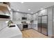 This modern kitchen features stainless steel appliances, gray cabinets and hardwood floors at 11415 Hutcheson Ferry Rd, Chattahoochee Hills, GA 30268