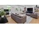 Cozy living room featuring stylish furnishings, open layout, wood-look flooring, and bright natural light at 11415 Hutcheson Ferry Rd, Chattahoochee Hills, GA 30268