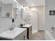 Bright bathroom featuring double sinks, shower and vanity with modern finishes and fixtures at 1265 Woodland Se Ave, Atlanta, GA 30316