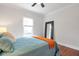 Bedroom featuring a comfortable bed, bedside table with a lamp, and a full-length mirror at 1265 Woodland Se Ave, Atlanta, GA 30316