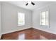 A cozy bedroom featuring hardwood floors and two windows offering natural light at 1265 Woodland Se Ave, Atlanta, GA 30316