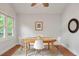 Light and bright dining room with a round wooden table and white chairs at 1265 Woodland Se Ave, Atlanta, GA 30316