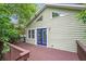 Exterior view of a home featuring a wooden deck, triangular windows and side yard at 1265 Woodland Se Ave, Atlanta, GA 30316