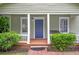 Charming home with a covered porch, manicured bushes, and a classic front door at 1265 Woodland Se Ave, Atlanta, GA 30316