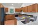 Bright kitchen features wood cabinets, black countertops, and a breakfast bar with barstool seating at 1265 Woodland Se Ave, Atlanta, GA 30316