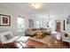 Inviting living room with hardwood floors, a comfortable sofa, and ample natural light at 1265 Woodland Se Ave, Atlanta, GA 30316