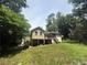Spacious backyard featuring a wooden deck and lush greenery, perfect for outdoor entertaining at 410 Lima Ct, Woodstock, GA 30188