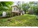 View of the home's backyard featuring a deck, grassy lawn, and natural surroundings at 410 Lima Ct, Woodstock, GA 30188