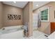 Bathroom featuring a soaking tub with a separate shower at 410 Lima Ct, Woodstock, GA 30188