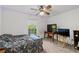 Bedroom with a ceiling fan, a large window, and carpeted floors at 410 Lima Ct, Woodstock, GA 30188