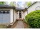 Charming home with a stone walkway, landscaped bushes, and a two-car garage at 410 Lima Ct, Woodstock, GA 30188