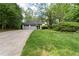 Charming home featuring an attached two-car garage and a lush, green front yard at 410 Lima Ct, Woodstock, GA 30188