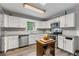 Bright kitchen featuring white cabinets, stainless steel appliances, tile backsplash, and a wooden island at 410 Lima Ct, Woodstock, GA 30188