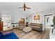 Cozy living room with wood floors, comfortable seating, and ample natural light at 410 Lima Ct, Woodstock, GA 30188