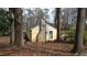 View of back of home, showing brick chimney and home exterior at 4622 Dogwood Rd, Pine Lake, GA 30072