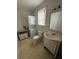 This bathroom features a standard toilet, vanity with sink, mirror, and a stacked washer dryer unit at 4622 Dogwood Rd, Pine Lake, GA 30072