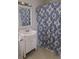 Bathroom featuring sink, mirror, and blue patterned shower curtain at 4622 Dogwood Rd, Pine Lake, GA 30072